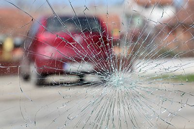 broken windshield with car visible through it | Monument Car Accident Attorney