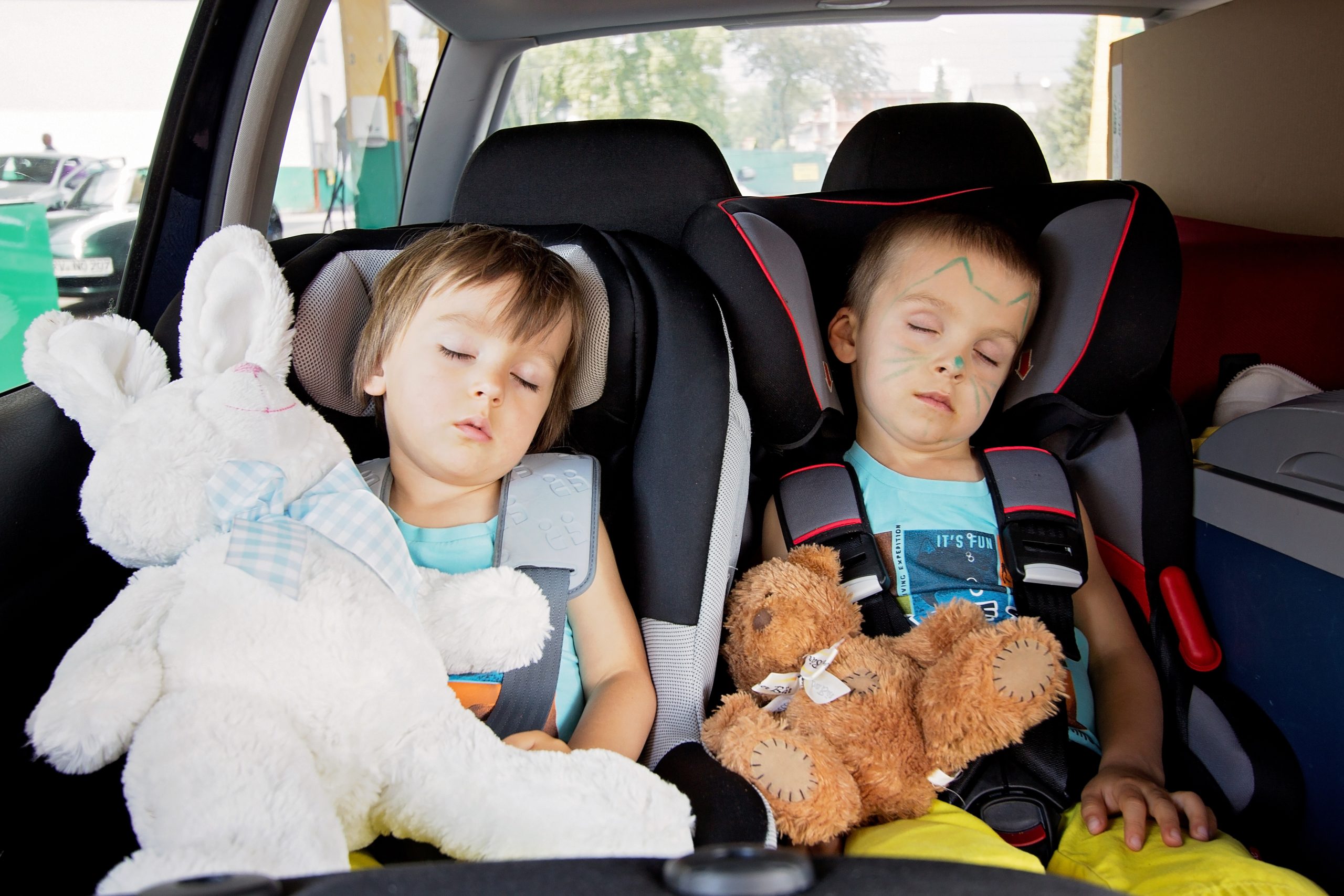 Two kids in car seats, travelling