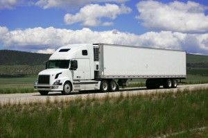 white truck driving down the highway during the day | Common Causes of Trucking Accidents