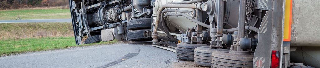 a semi truck on it's side after an accident| Colorado Springs Trucking Accident Attorneys
