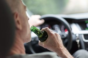 man drinking a beer while driving | Could Your Car Stop You From Drunk Driving