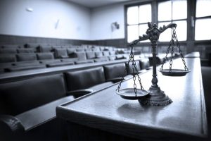 scales of justice on desk in courtroom | Colorado Statute of Limitations